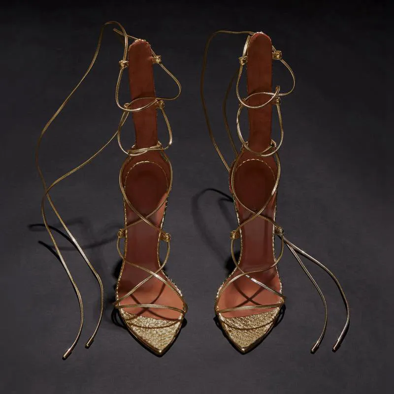 Pointed golden Roman cross strapped boots with thin heels